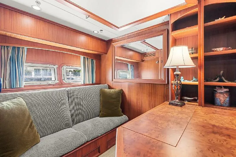 Slide: The Image of Luxurious interior of a 2006 Paragon Cockpit Motoryacht with wood paneling and cozy seating. - 16