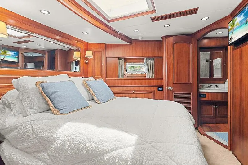 Slide: The Image of Luxurious bedroom in 2006 Paragon Cockpit Motoryacht with wood paneling and cozy bedding. - 17