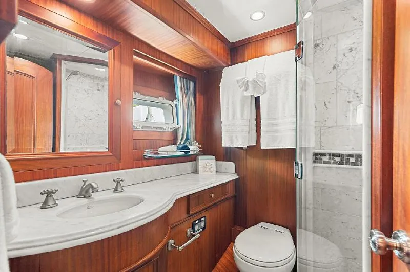 Slide: The Image of Luxurious bathroom in 2006 Paragon Cockpit Motoryacht with wood accents and marble shower. - 18