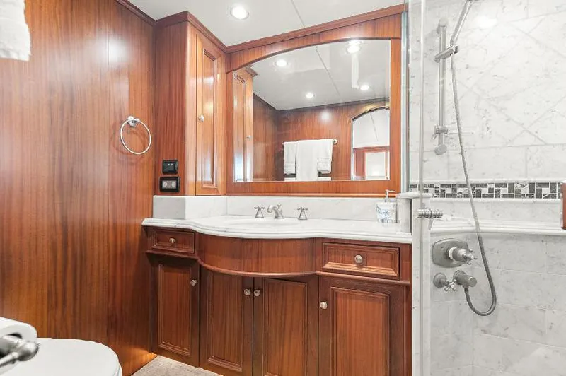 Slide: The Image of Luxurious bathroom in 2006 Paragon Cockpit Motoryacht with wood cabinetry and marble accents. - 19