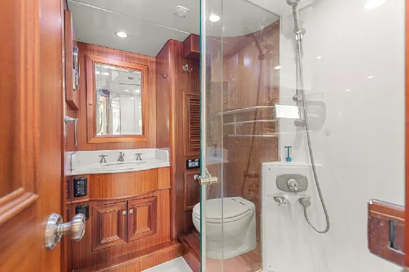 Slide: The Image of Luxurious bathroom in 2006 Paragon Cockpit Motoryacht with wood accents and modern fixtures. - 25