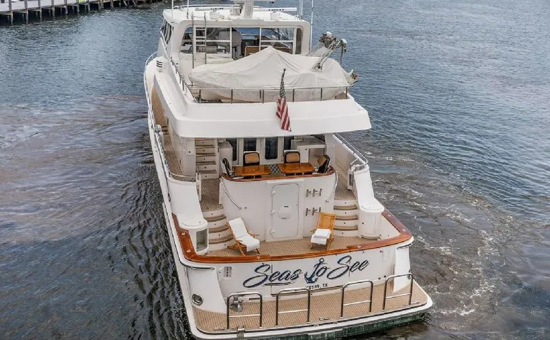 Slide: The Image of 2006 Paragon Cockpit Motoryacht on water, rear view with deck chairs and American flag. - 29