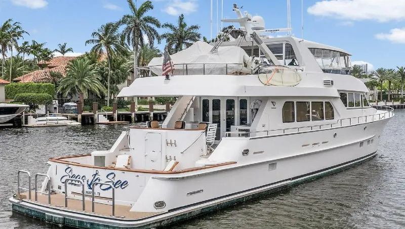 Slide: The Image of 2006 Paragon Cockpit Motoryacht docked in a tropical marina setting. - 30