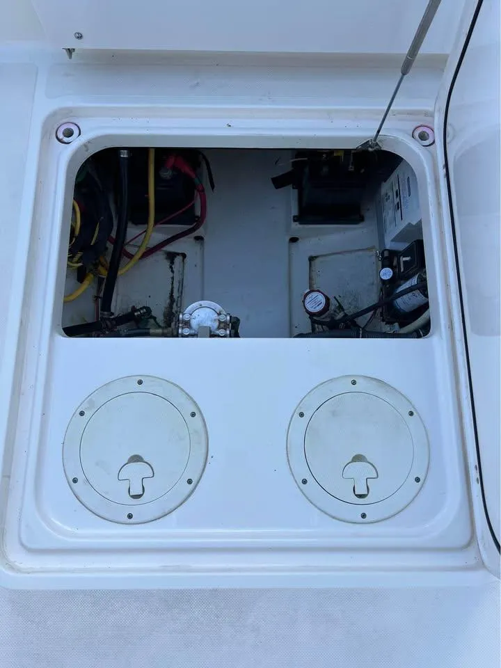 Slide: The Image of 2014 Pursuit DC 265 Dual Console boat with Yamaha outboard motor, parked on grass. - 10