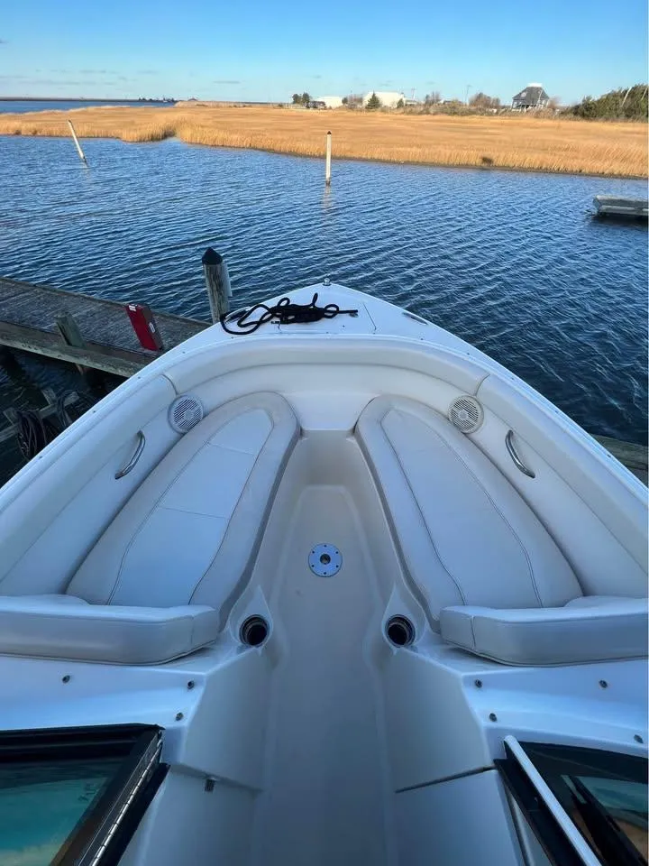 Slide: The Image of 2014 Pursuit DC 265 Dual Console boat docked by serene waters. - 20