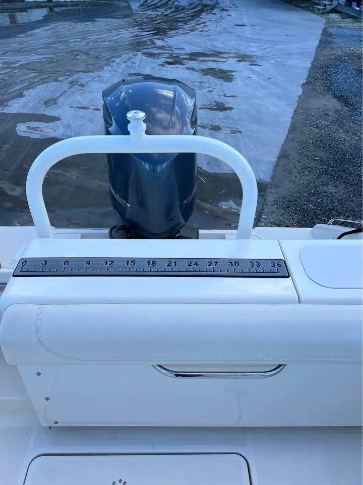 Slide: The Image of 2014 Pursuit DC 265 Dual Console boat with outboard motor and measuring scale. - 25