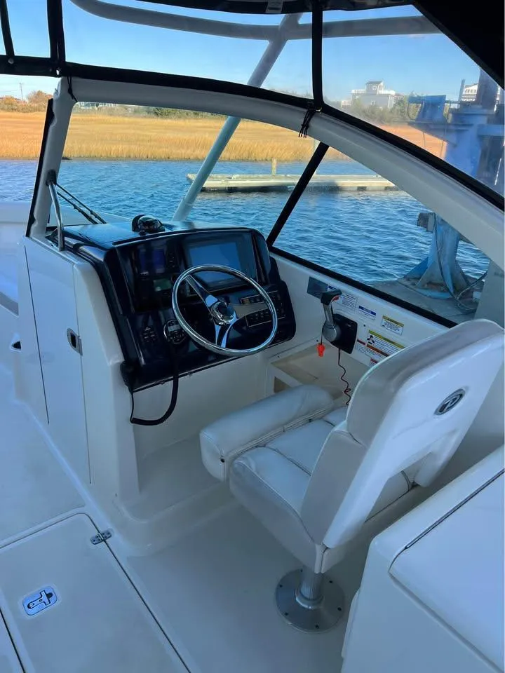 Slide: The Image of 2014 Pursuit DC 265 Dual Console boat on trailer at Cedar Creek Marine Center. - 6