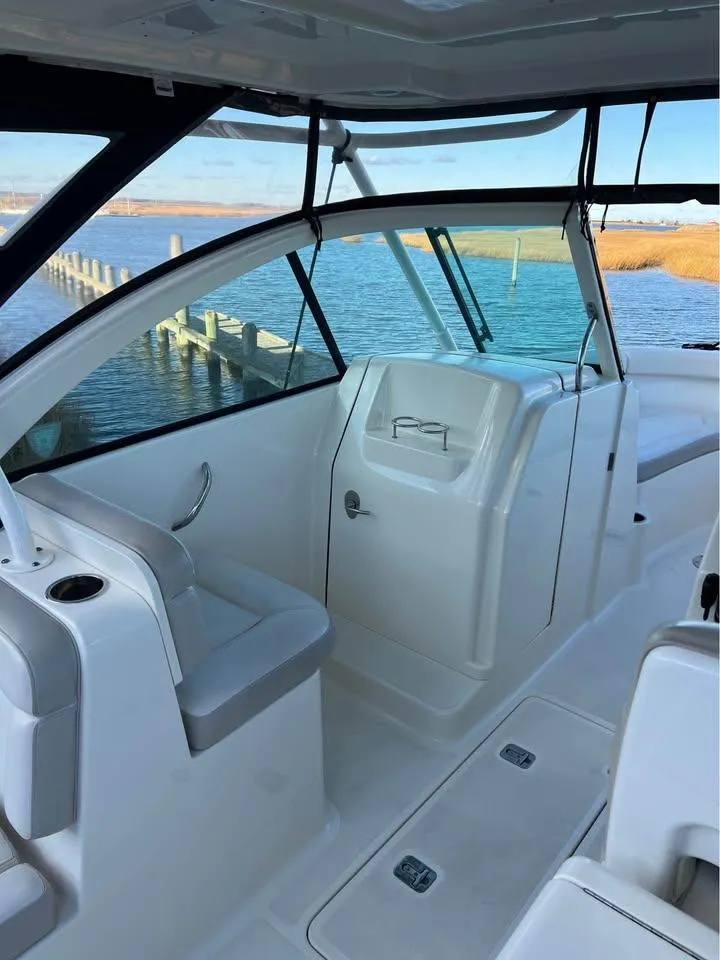 Slide: The Image of 2014 Pursuit DC 265 Dual Console boat on trailer, parked on grassy area. - 9