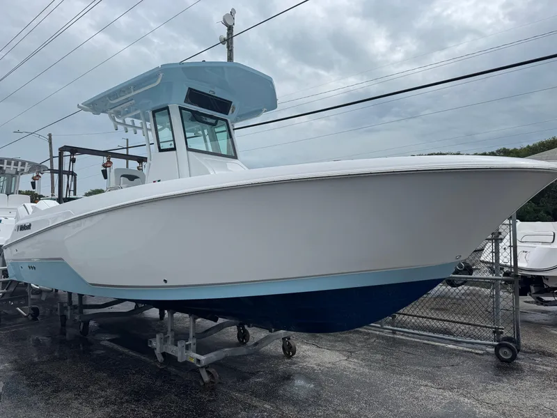 The Image of 2025 Wellcraft 263 Fisherman boat displayed outdoors on a cloudy day. - 1