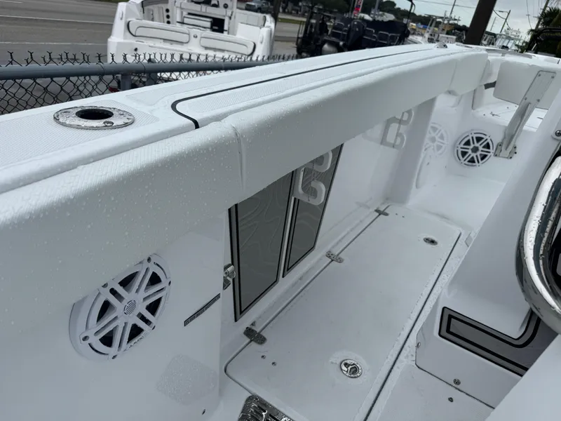 Slide: The Image of 2025 Wellcraft 263 Fisherman boat interior with speakers and storage compartments. - 14