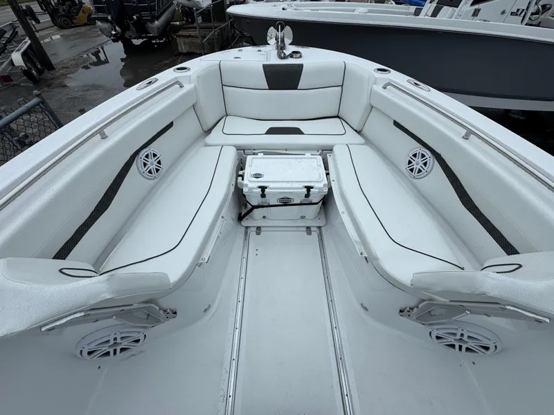 Slide: The Image of 2025 Wellcraft 263 Fisherman boat interior with white seating and storage. - 24