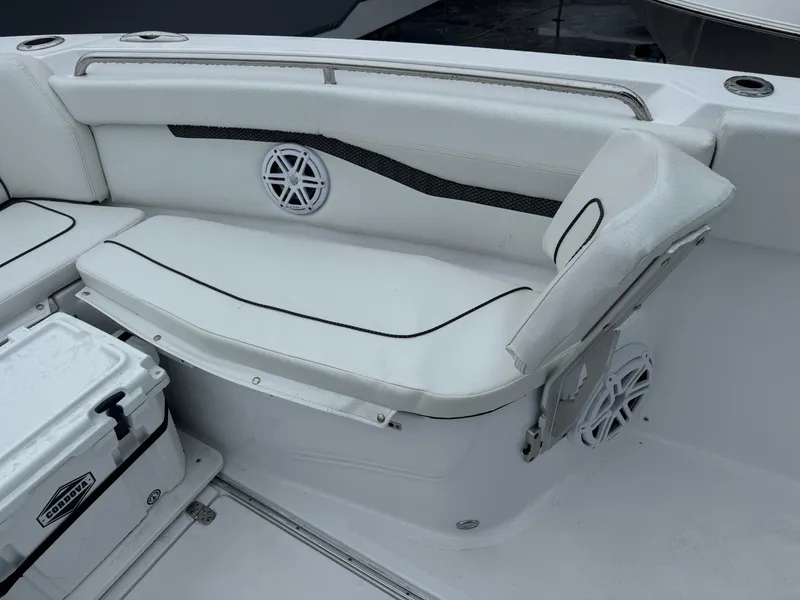 Slide: The Image of 2025 Wellcraft 263 Fisherman boat interior with white seating and storage compartment. - 25