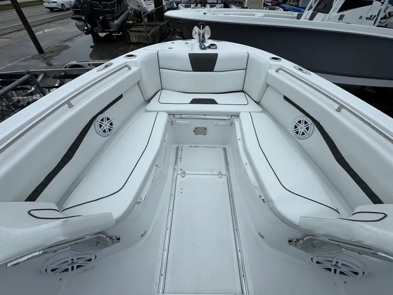 Slide: The Image of 2025 Wellcraft 263 Fisherman boat interior with white seating and speakers. - 27