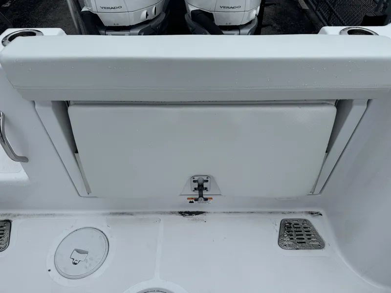 Slide: The Image of 2025 Wellcraft 263 Fisherman boat interior with storage compartment and dual outboard engines. - 31
