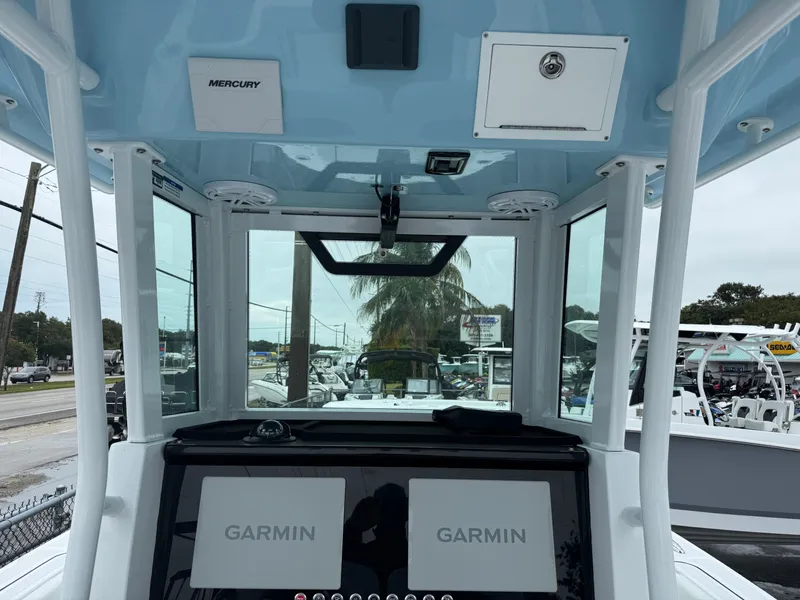 Slide: The Image of 2025 Wellcraft 263 Fisherman boat dashboard with dual Garmin displays and Mercury controls. - 8
