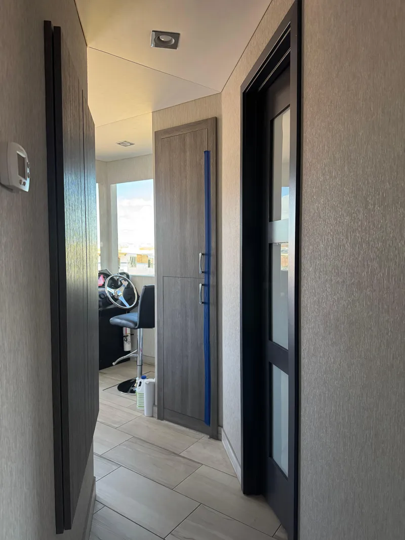 Slide: The Image of Hallway inside 2017 Adonia KSIX RV, featuring modern interior design and steering wheel view. - 16