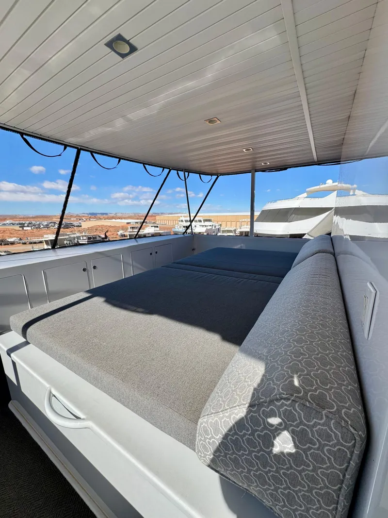 Slide: The Image of 2017 Adonia KSIX houseboat with spacious deck and comfortable seating under a canopy. - 19