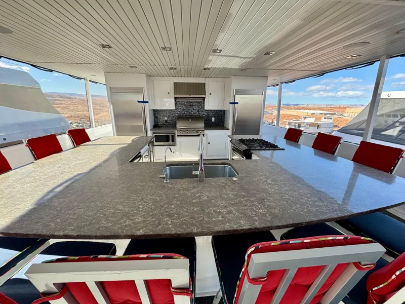 Slide: The Image of Luxurious kitchen area on 2017 Adonia KSIX houseboat with modern appliances and seating. - 21
