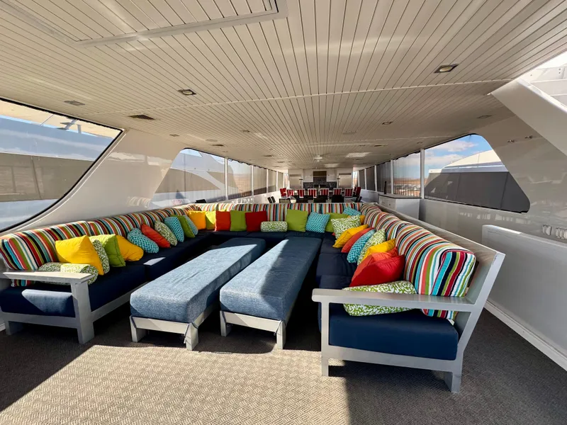 Slide: The Image of Luxurious interior of 2017 Adonia KSIX yacht with colorful seating and panoramic windows. - 24