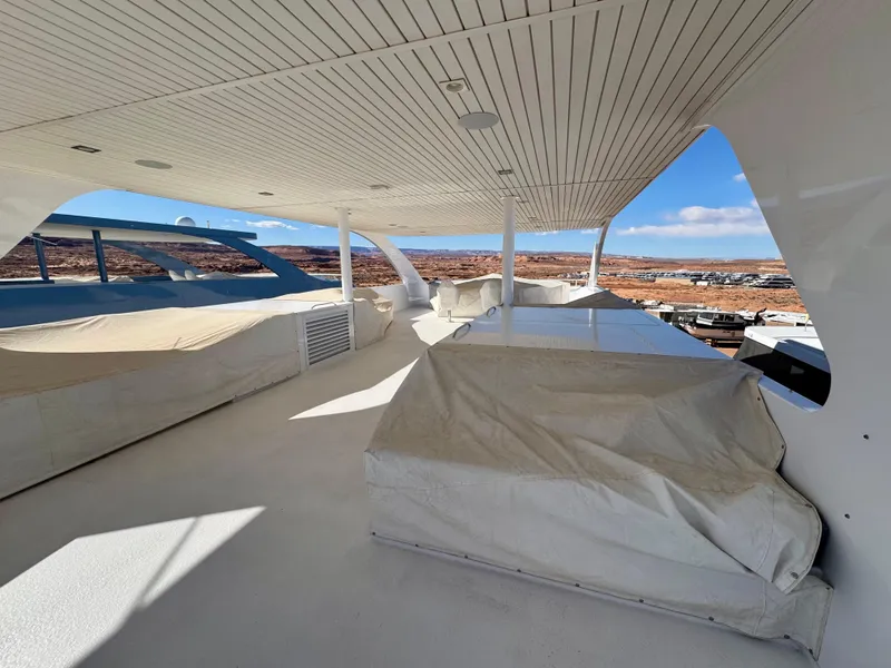 Slide: The Image of Upper deck of 2017 Adonia KSIX yacht with covered seating, overlooking scenic landscape. - 25