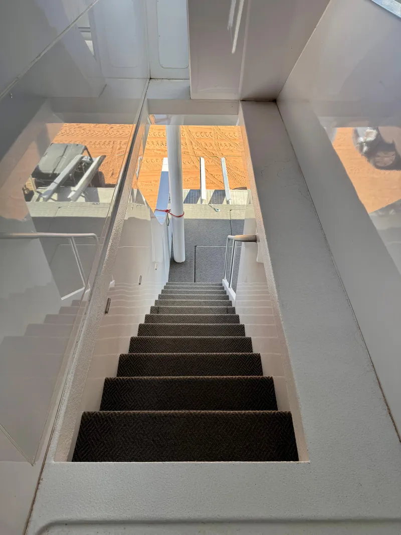 Slide: The Image of Staircase inside 2017 Adonia KSIX yacht, leading to lower deck with outdoor view. - 30