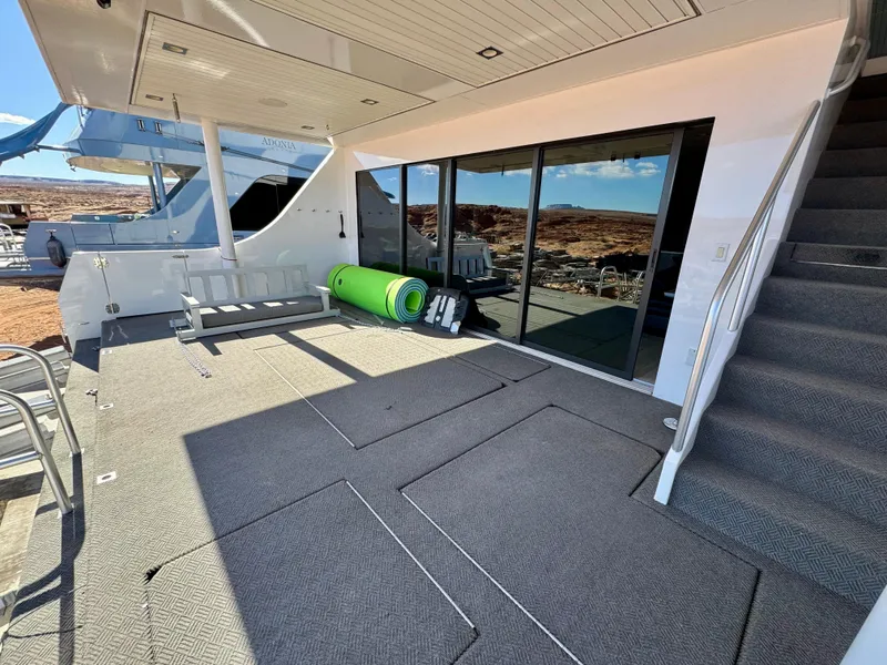 Slide: The Image of 2017 Adonia KSIX yacht deck with outdoor seating and scenic view. - 32