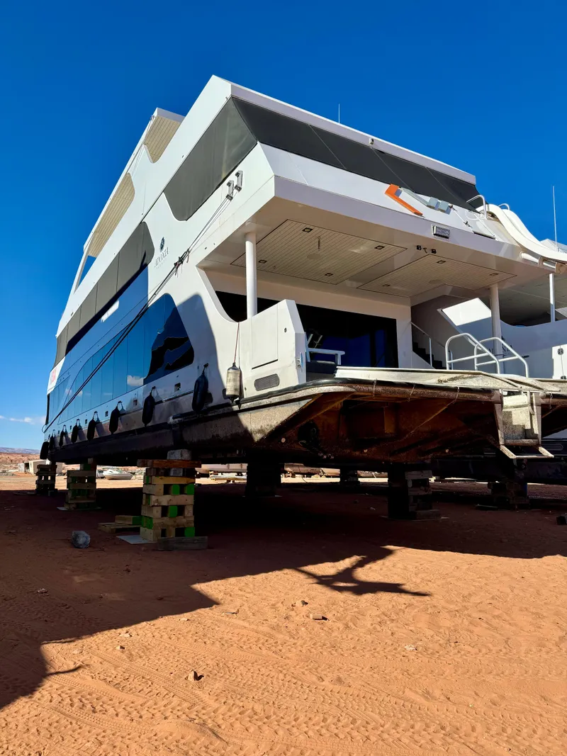 Slide: The Image of 2017 Adonia KSIX houseboat on dry land under clear blue sky. - 33