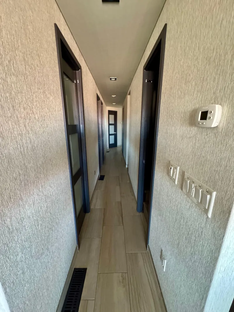 Slide: The Image of Narrow hallway in 2017 Adonia KSIX with modern decor and wooden flooring. - 4