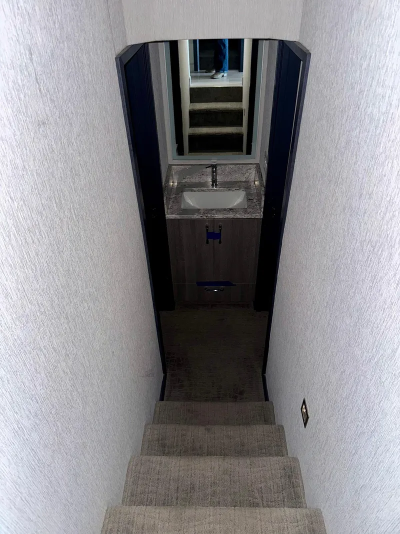 Slide: The Image of Narrow stairway leading to a compact bathroom in a 2017 Adonia KSIX. - 7