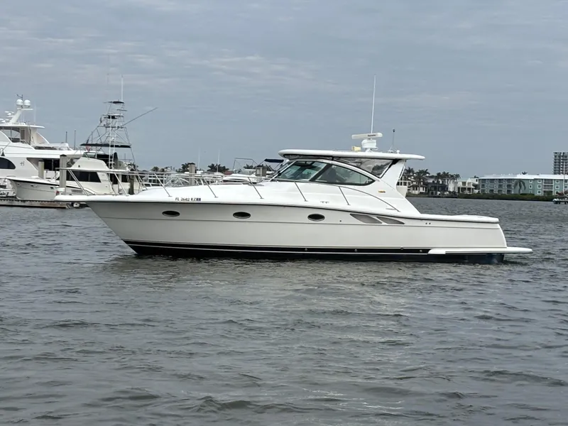 Slide: The Image of 2005 Tiara Yachts 3800 Open cruising on a calm waterway, with other boats in the background. - 0