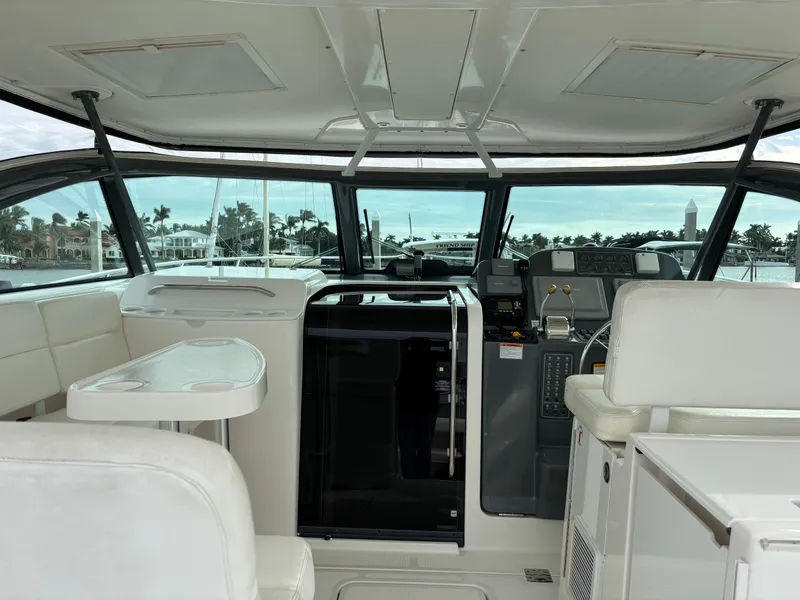 Slide: The Image of Interior of 2005 Tiara Yachts 3800 Open, featuring helm and seating area with ocean view. - 15