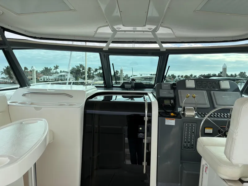 Slide: The Image of 2005 Tiara Yachts 3800 Open helm with modern controls and panoramic view. - 16