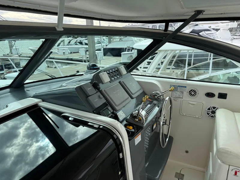 Slide: The Image of 2005 Tiara Yachts 3800 Open helm with navigation equipment and marina view. - 17