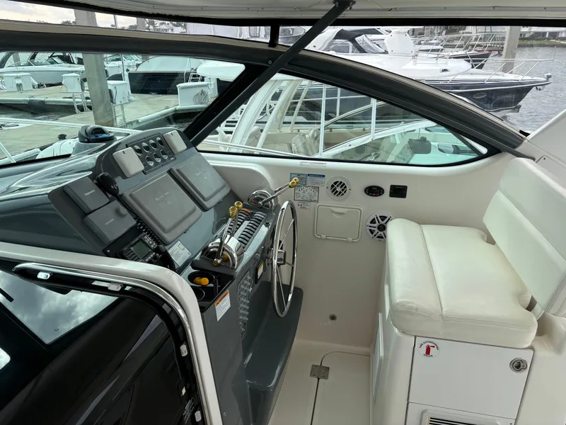 Slide: The Image of 2005 Tiara Yachts 3800 Open helm with modern controls and comfortable seating at marina. - 18