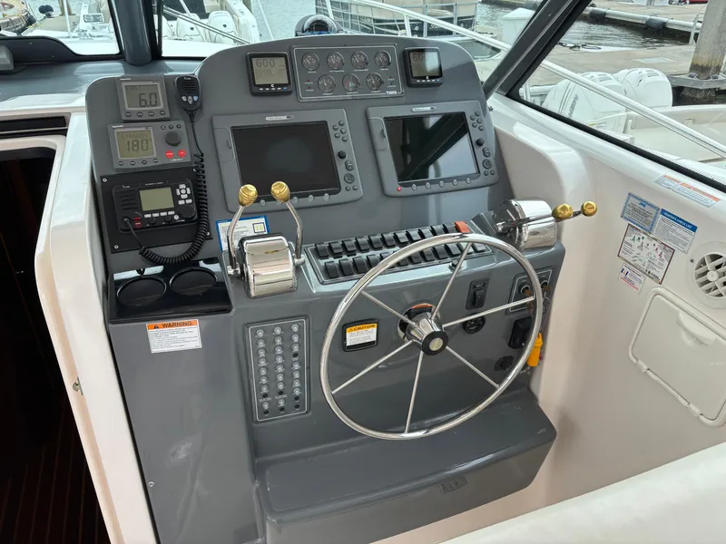Slide: The Image of 2005 Tiara Yachts 3800 Open helm with navigation controls and steering wheel. - 20