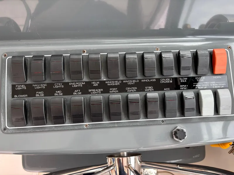 Slide: The Image of Control panel of a 2005 Tiara Yachts 3800 Open, featuring various switches and labels. - 27