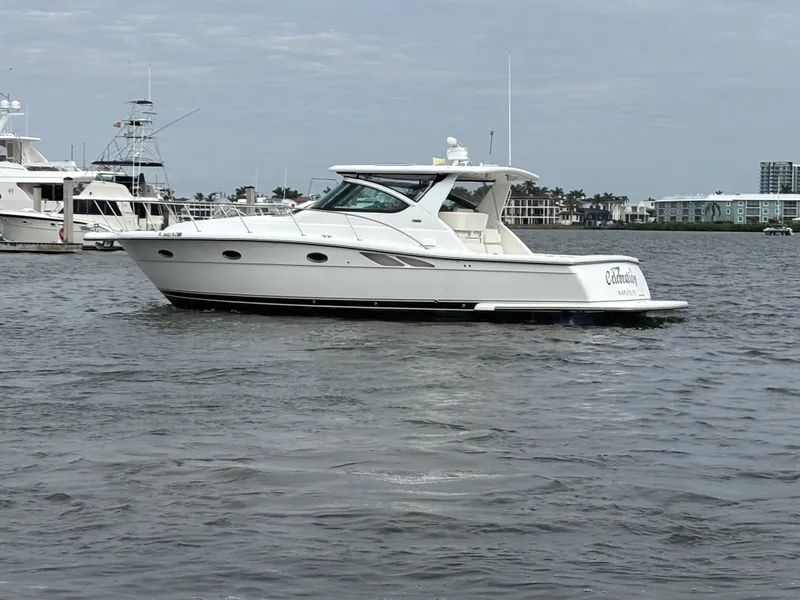 Slide: The Image of 2005 Tiara Yachts 3800 Open cruising on a calm waterway, with marina in the background. - 3