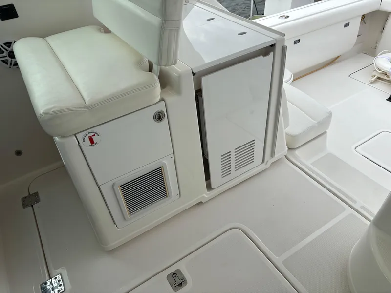 Slide: The Image of 2005 Tiara Yachts 3800 Open interior with white seating and storage compartments. - 30