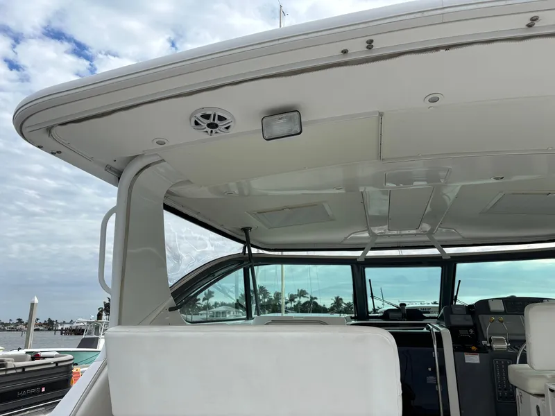 Slide: The Image of 2005 Tiara Yachts 3800 Open, interior view, featuring helm and seating area. - 40