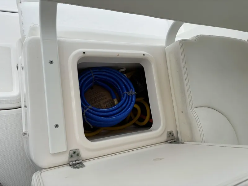 Slide: The Image of Storage compartment on a 2005 Tiara Yachts 3800 Open, containing coiled hoses. - 45