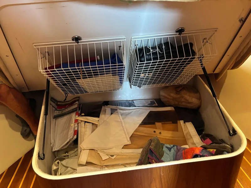 Slide: The Image of Storage compartment in a 2005 Tiara Yachts 3800 Open, featuring organized shelves and various items. - 63