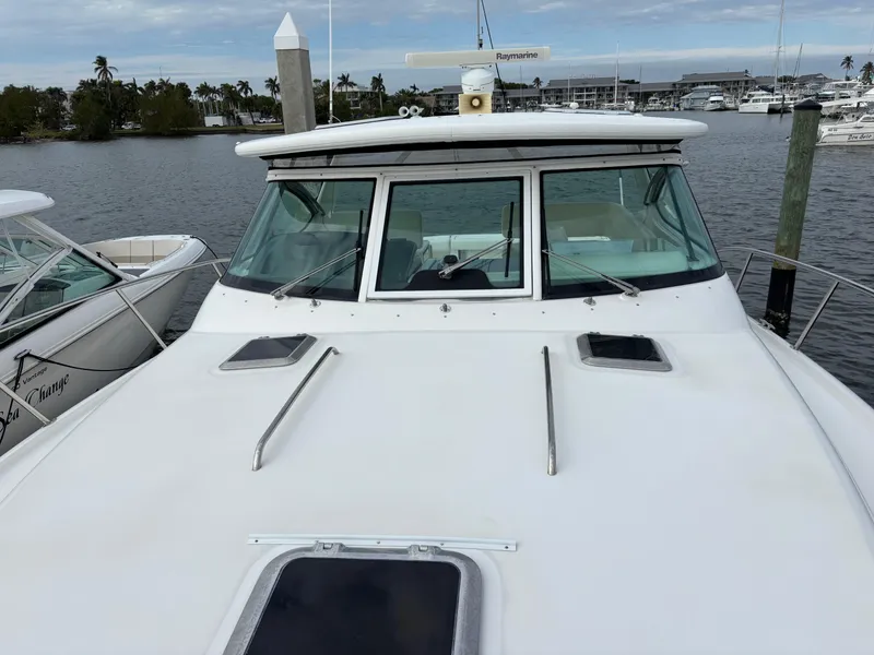 Slide: The Image of 2005 Tiara Yachts 3800 Open docked, showcasing sleek design and spacious deck. - 9