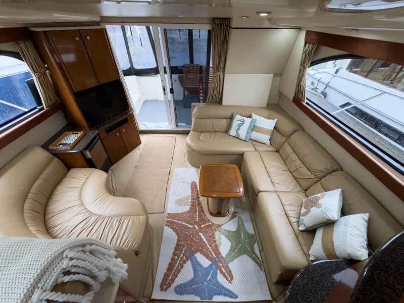 Slide: The Image of Luxurious interior of 2006 Meridian 411 Sedan yacht with plush seating and nautical decor. - 14
