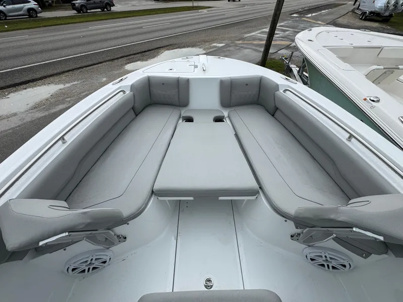 Slide: The Image of 2025 Wellcraft 223 Fisherman boat interior with cushioned seating and speakers. - 13