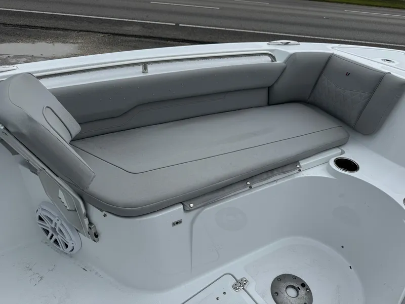 Slide: The Image of 2025 Wellcraft 223 Fisherman boat interior with gray seating and cup holder. - 16
