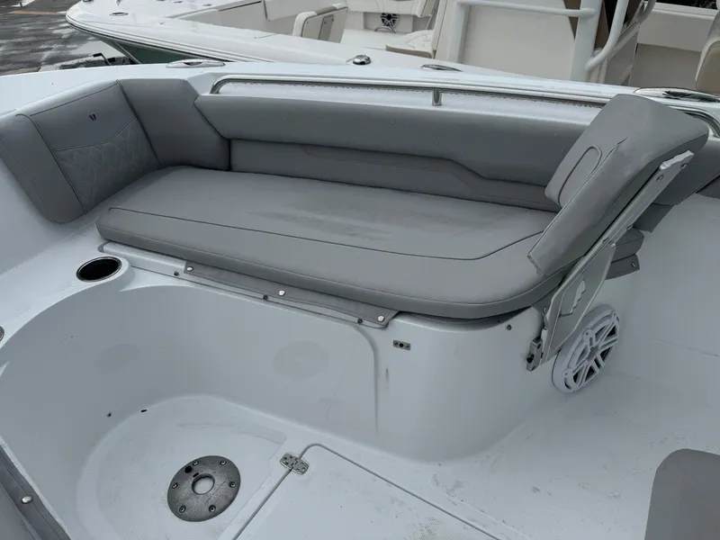 Slide: The Image of 2025 Wellcraft 223 Fisherman boat interior with gray seating and cup holder. - 17