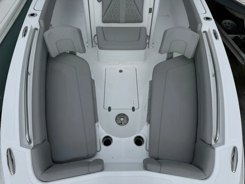 Slide: The Image of 2025 Wellcraft 223 Fisherman boat interior with gray seating and storage compartments. - 20