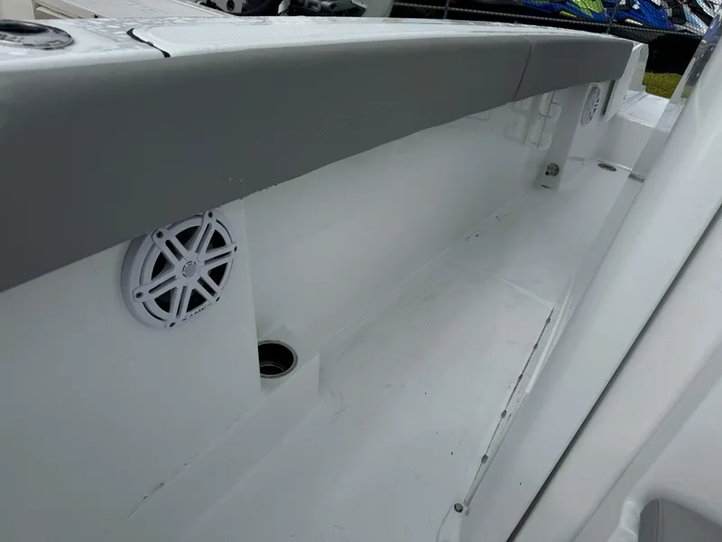 Slide: The Image of 2025 Wellcraft 223 Fisherman boat interior with speaker and storage area. - 22