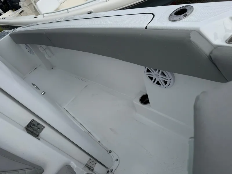 Slide: The Image of 2025 Wellcraft 223 Fisherman boat interior with seating and speaker detail. - 23
