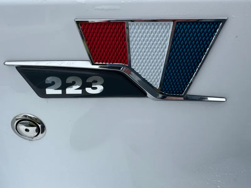 Slide: The Image of 2025 Wellcraft 223 Fisherman emblem with red, white, and blue design. - 4